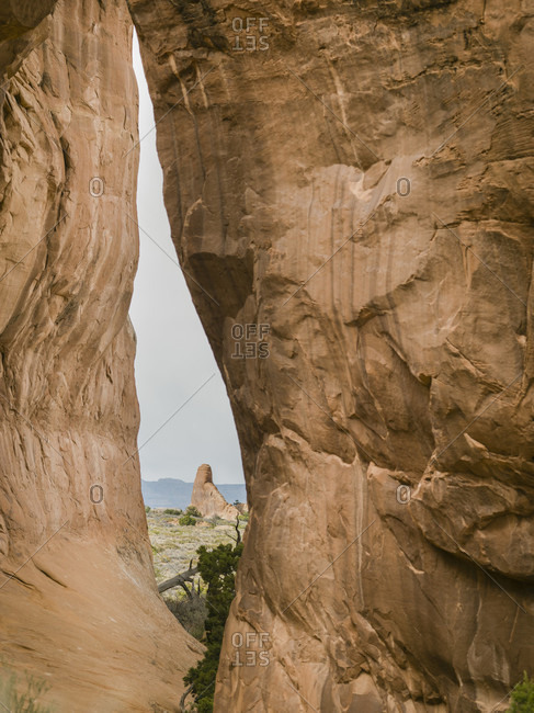 View through Pine Tree Arch off the Devil\'s Playground Trail in Arches National Park, Moab, Utah