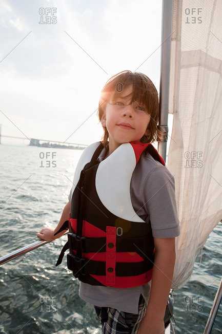 Young boy on board yacht at dusk