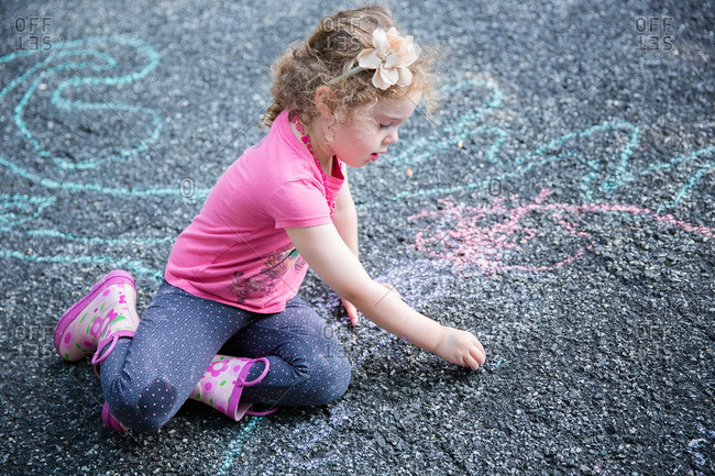 Girl drawing on pavement