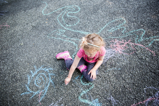 A girl chalk drawing on pavement