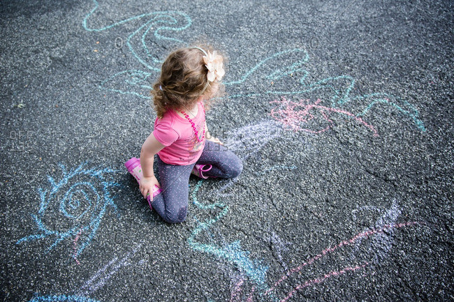 Girl using sidewalk chalk