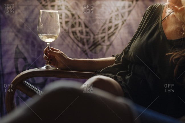 Woman lounging with glass of wine