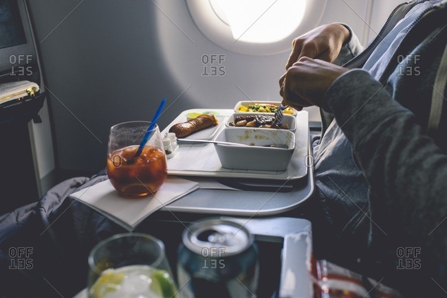 Man eating meal on plane