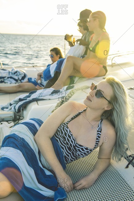 Woman and friends lounging on boat