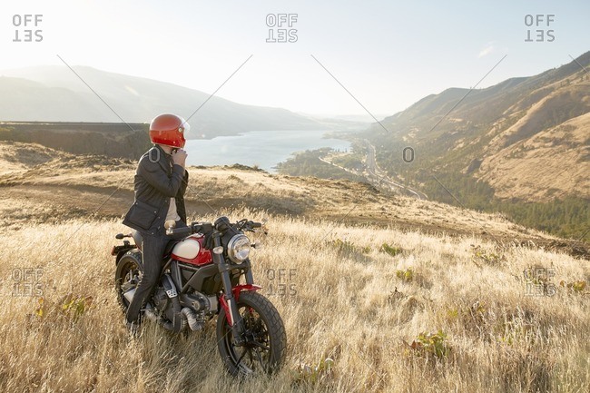 Man on motorcycle overlooking valley