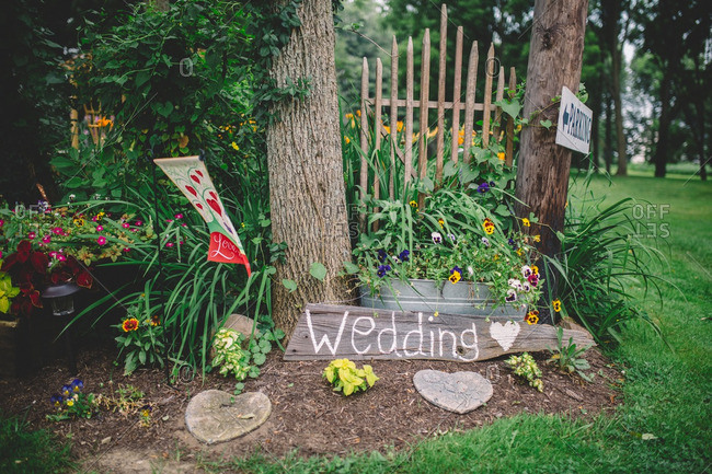 Small garden displaying a parking sign for wedding guests