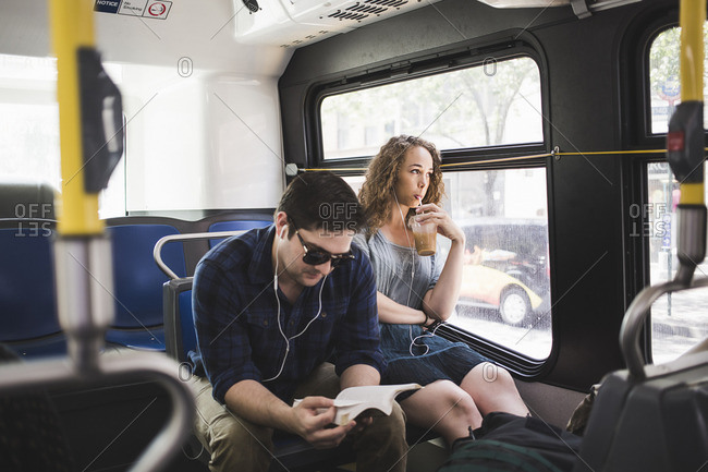 Man and woman riding a bus