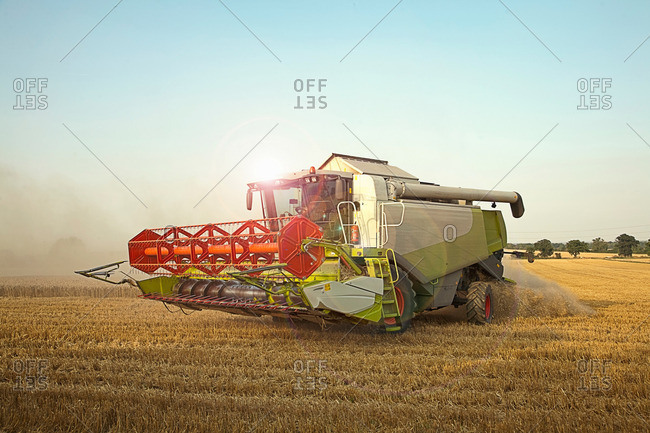 Combine harvester in field, Devon, England, UK