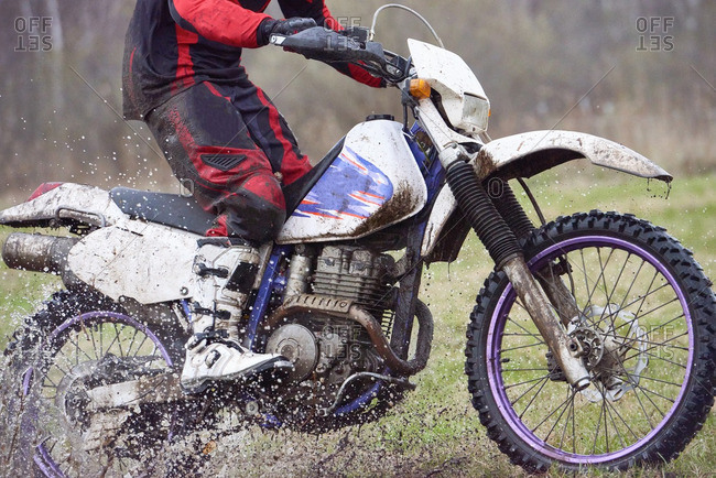 Motorcyclist racing in mud