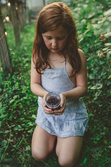 Girl with jar of berries