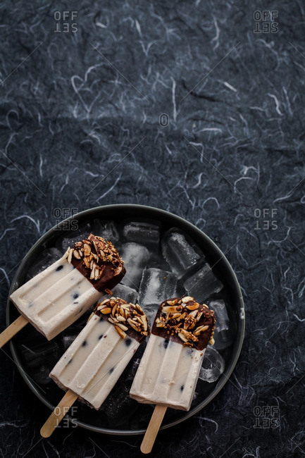 Almond butter blueberry popsicles on an iced tray