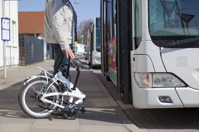 Germany- Wunstdorf- bus station- man with folding bicycle in front of bus