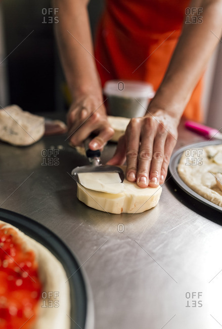 Woman\'s hand using cheese slicer