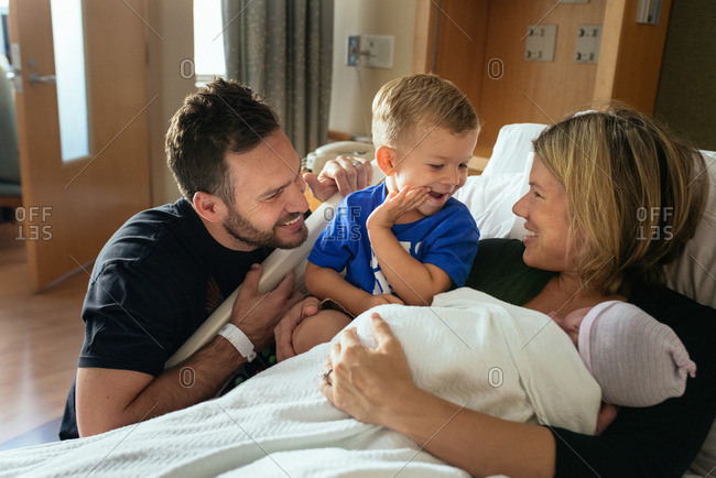 Family spending time together in a hospital after the birth of their baby