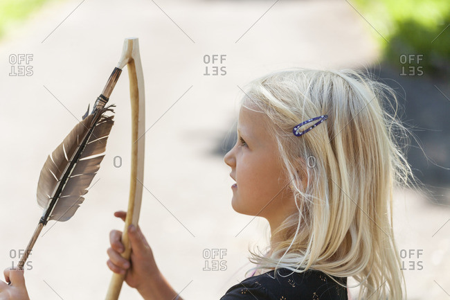 Girl holding Stone-Age spear-thrower