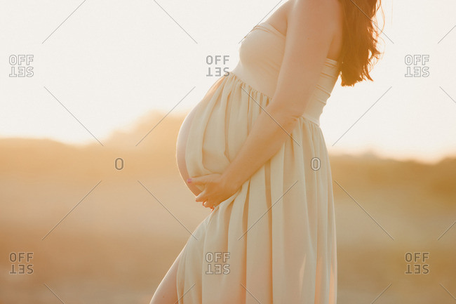Pregnant woman wearing long flowing dress