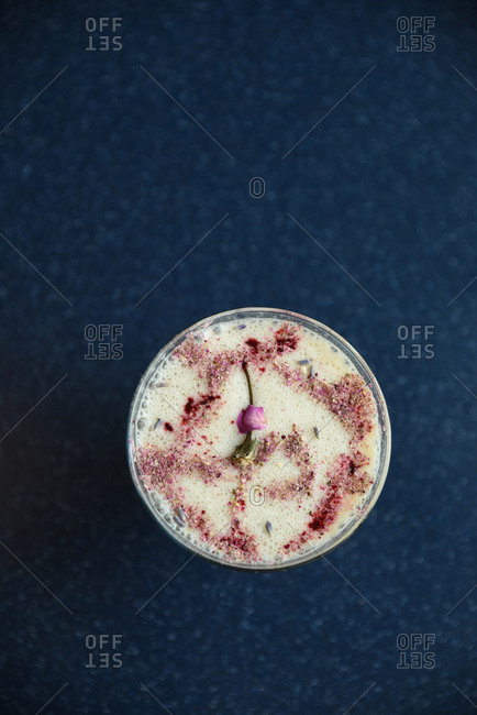 Frothy, creamy drink topped with crushed rose petals