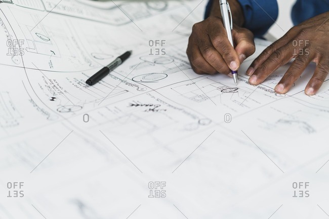 Man revising building blueprints