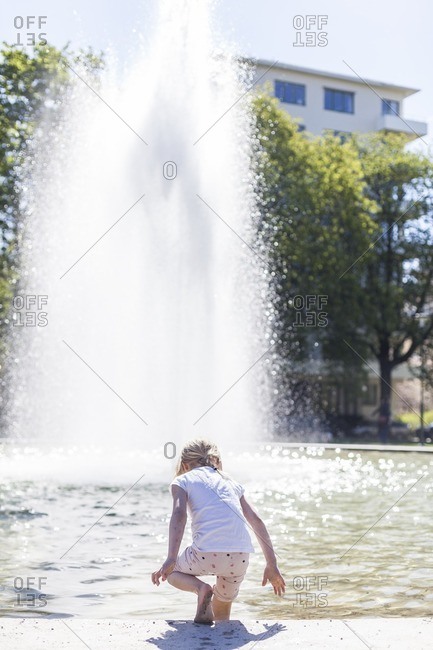 A girl and a water fountain.