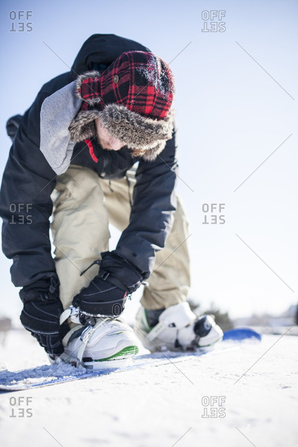 Two young guys out snowboarding together on cold winter day