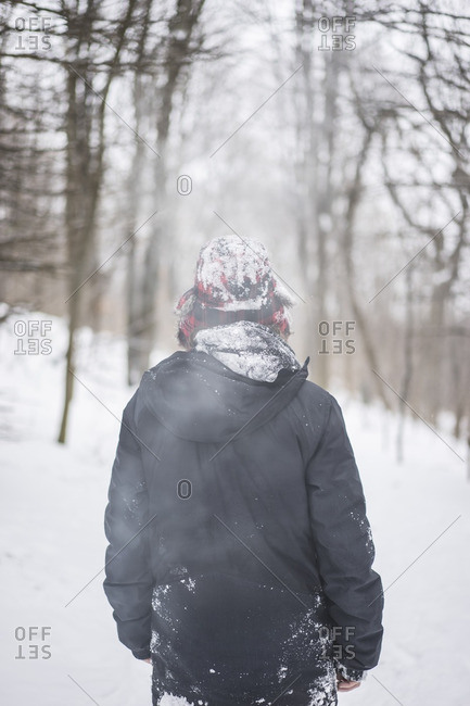 Young man enjoying Canadian winter in forest, Mont royal, Montreal, Quebec, Canada