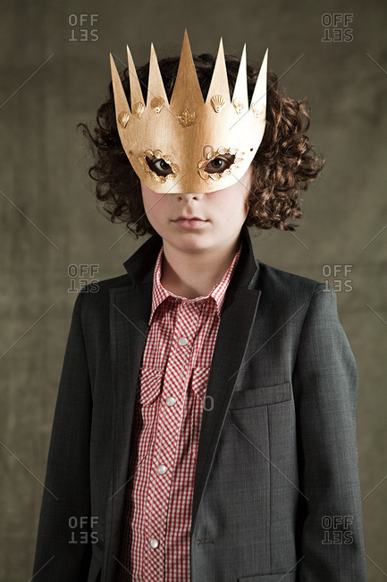 Young boy wearing gold crown mask