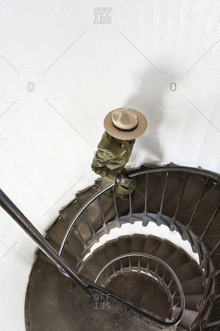 Park ranger walking up stairs in lighthouse at Alcatraz Island, California
