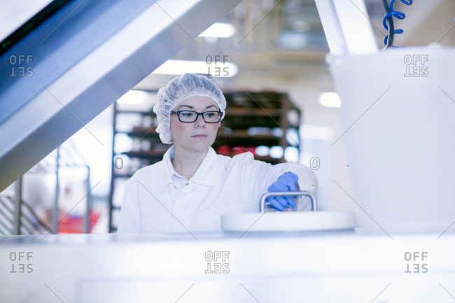 Factory worker wearing hair net in food production factory