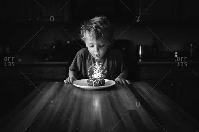 Boy blowing out candle on his cake