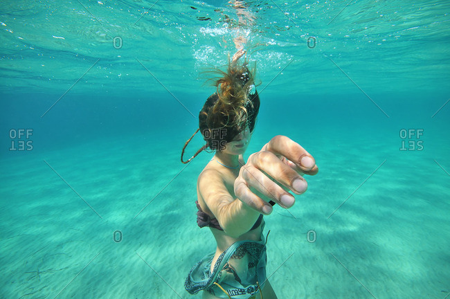 Woman moving hand underwater