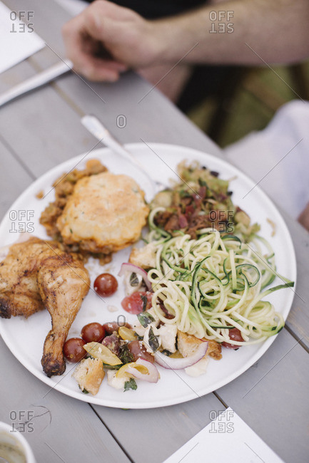 Food on a plate at a garden party, grilled chicken and salad