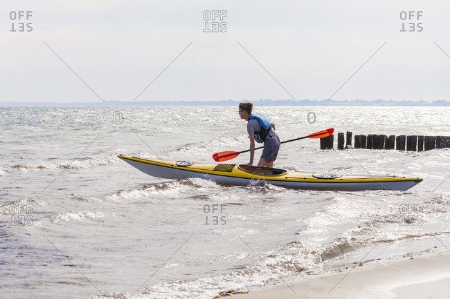 Denmark, Young man kayaking