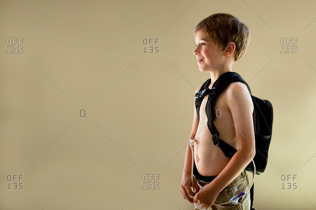 Boy with feeding tube backpack