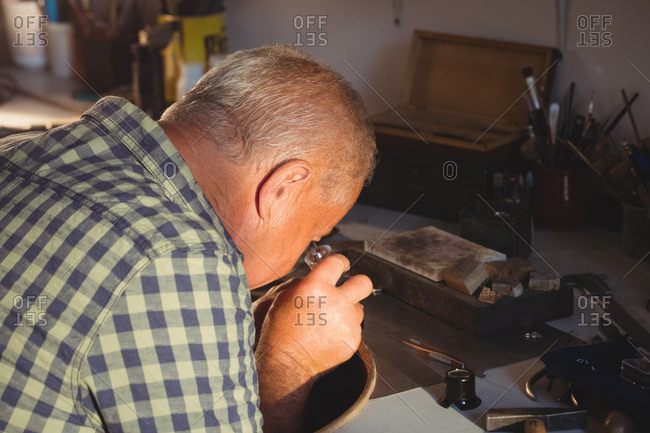 A man inspecting diamond