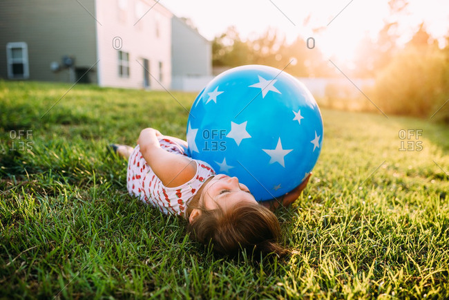 Girl lying with bouncy ball
