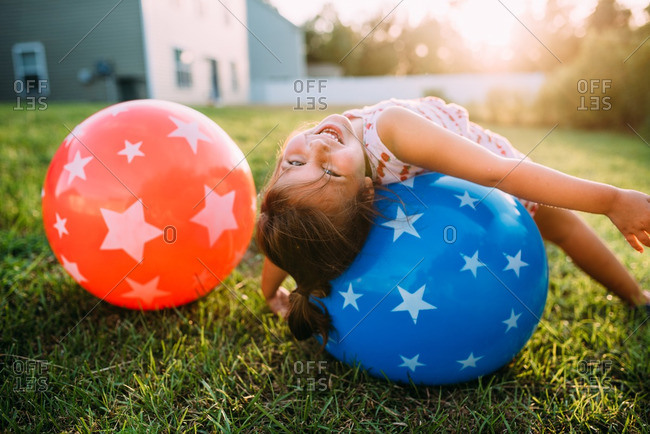 Girl lying on bouncy ball