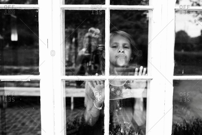 Girl pressing her face to window