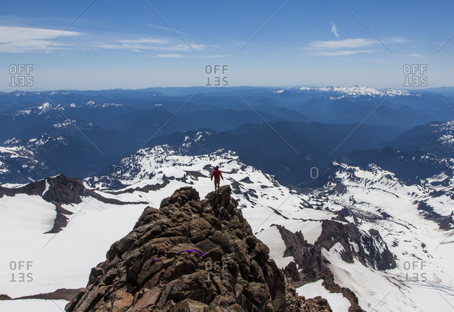 Long Exposure Of Man Standing On Top Of Rocky Mountain