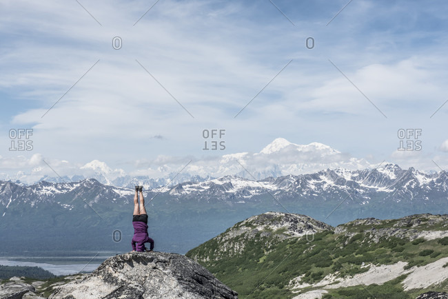 A Woman Doing Head Stand With Denali And The Alaska Range In The Background