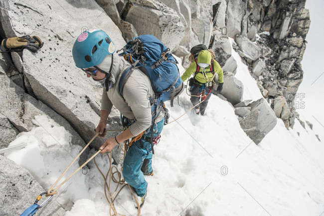 A Woman Belays Her Climbing Partner Above The Pika Glacier In Denali National Park
