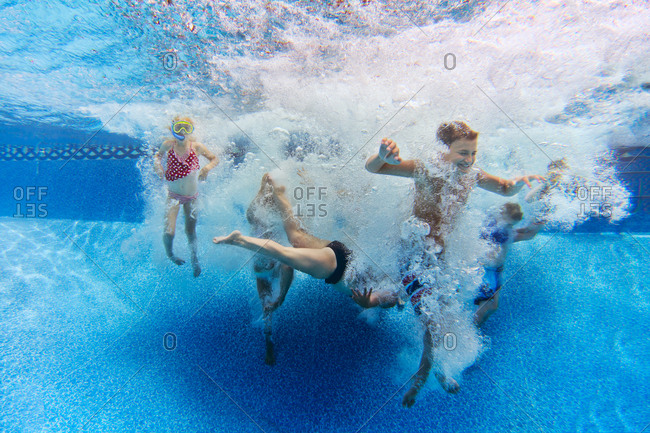Kids in pool water after jump