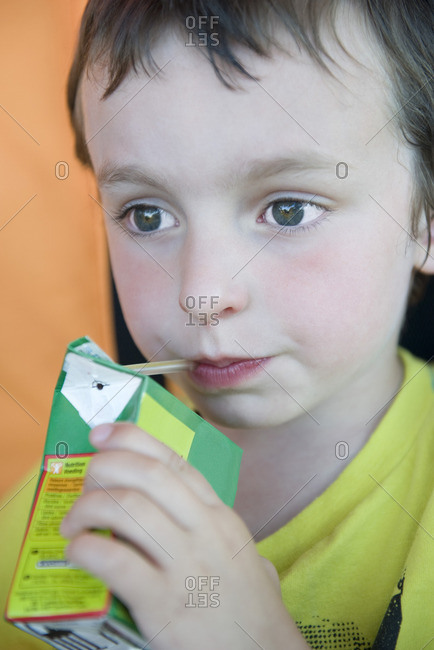 Little boy drinking juice box