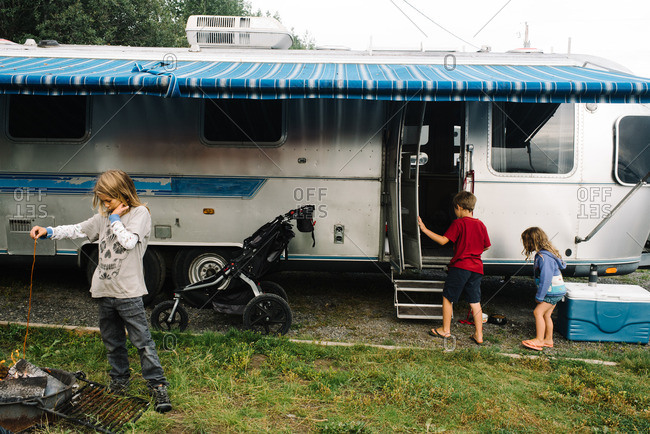 Kids by a camping trailer