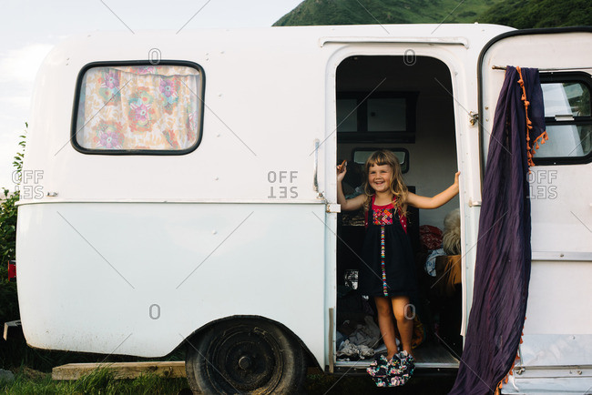 Girl in door of camper trailer
