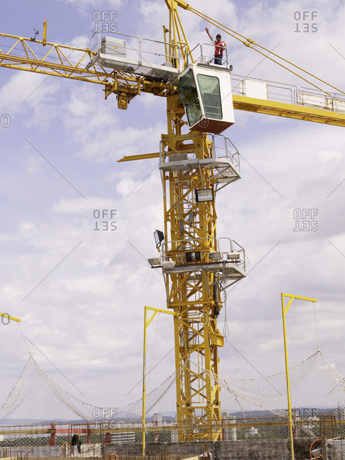 Construction worker on top of crane