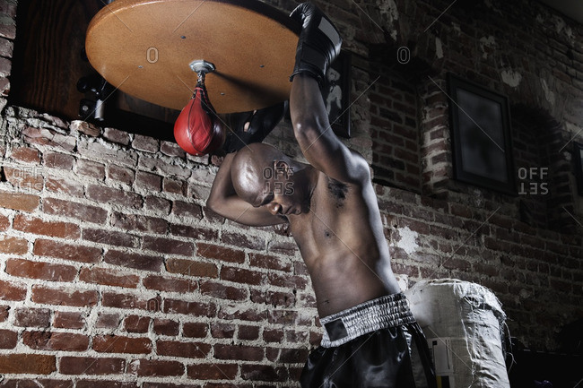 Tired African boxer at speed bag