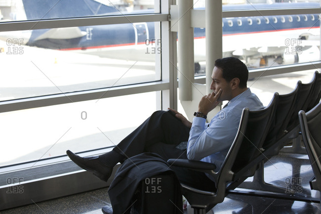 Hispanic business traveler waiting in airport