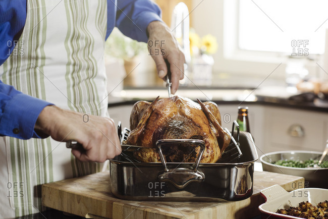 Man preparing to carve Thanksgiving turkey