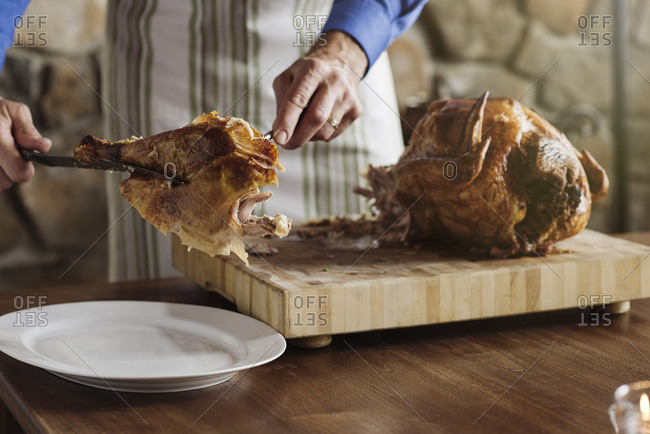 Man carving Thanksgiving turkey