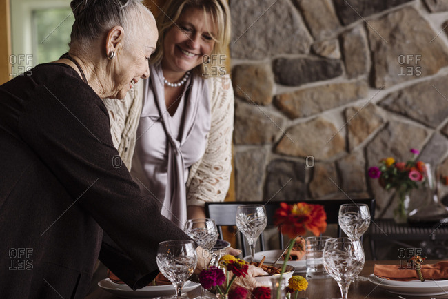 Women setting foot at the table for Thanksgiving dinner party